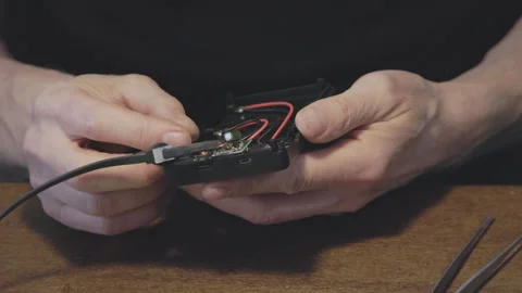 Handson Electronic Repair Effectively Connecting Wires and Components in Stock Footage 320950747