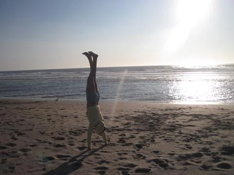 Handstand on the beach Stock Photos