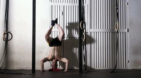 Handstand push-ups exercise - young athletic man doing gym workout Stock Footage 65279963