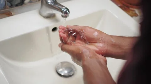 Handwashing method in a kitchen sink at home Stock Footage 340496188