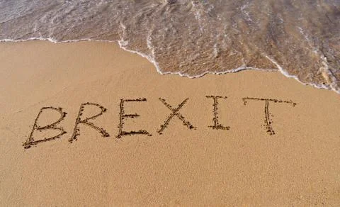 Handwrite text Brexit on sand coastline Stock Photos