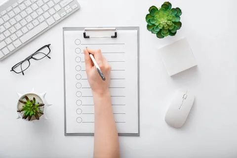 Handwriting on empty list in notepad to do list. Female hands do notes on paper Stock Photos