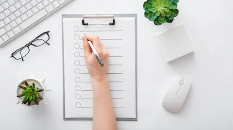 Handwriting on empty list in notepad to do list. Female hands do notes on tablet Stock Photos