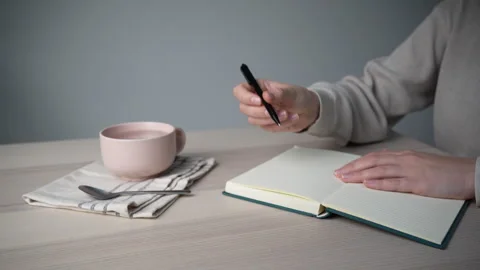 Handwriting notes in planner at desk Video stock 328003922