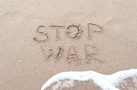 Handwriting stop war on the sandy beach 写真素材