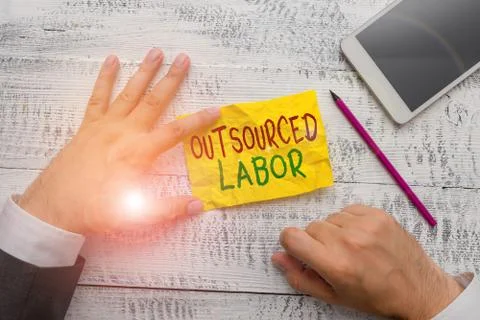 Handwriting text Outsourced Labor. Concept meaning jobs handled or getting done Photos