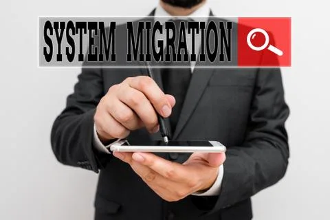 Handwriting text writing System Migration. Concept meaning moving from the use Stock Photos