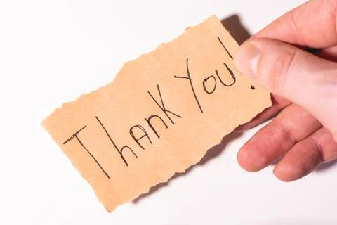 A handwriting  Thank you note on brown paper, on a white background Stock Photos