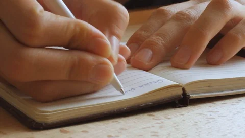 Handwriting, writing diary in paper notebook, closeup of hand with pen Stock Footage 120538940