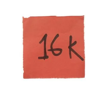 Handwritten 16k text on a square orange paper note isolated on white backgrou Stock Photos