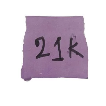 Handwritten 21k text on a square grey paper note isolated on white background Stock Photos