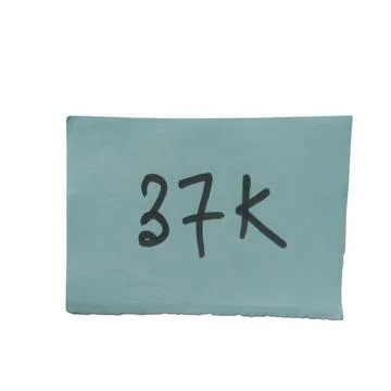 Handwritten 37k text on a light blue paper note isolated on white background Stock Photos