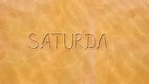 Handwritten animated text in the sand, the day of the week is Saturday. Stock Footage 130754356