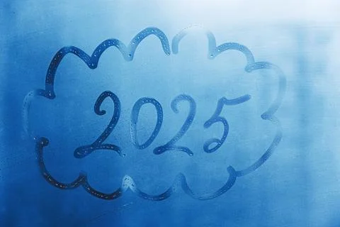 Handwritten arabic numerals 2025 in shape of doodle cloud on misted glass on Stock Photos
