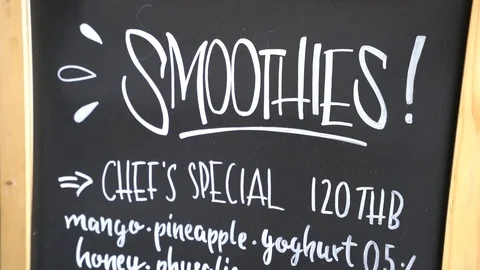Handwritten food and drinks menu on blackboard. Tilt down and hand held Stock-Footage 86061330
