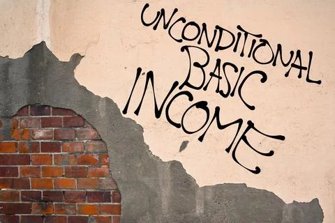 Handwritten graffiti Unconditional Basic Income sprayed on the wall, anarchis Stock Photos