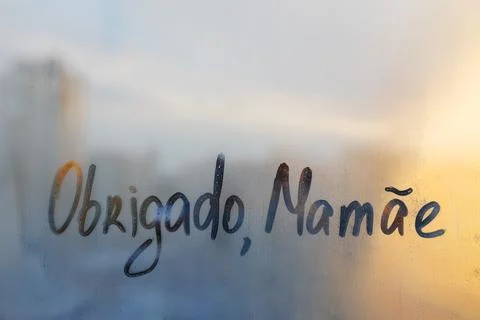 Handwritten lettering text Obrigado Mamae in Portuguese language is Thank you Stock Photos
