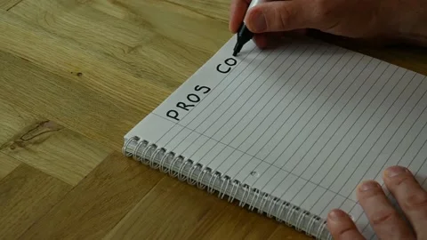 A handwritten list of pros and cons being started Stock Footage 229249011