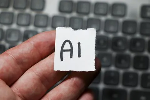 Handwritten note displaying the term AI, symbolizing artificial intelligence 스톡 사진