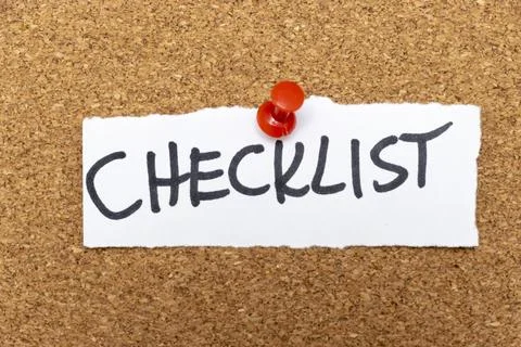 A handwritten note displaying the word CHECKLIST pinned to a corkboard, Stock Photos