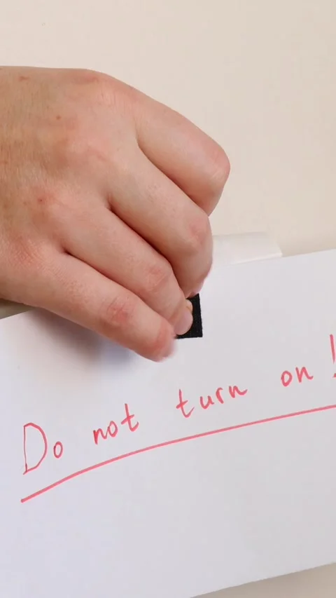 Handwritten note reading “Do not turn on!” taped to white radiator. Stock Footage 293335985
