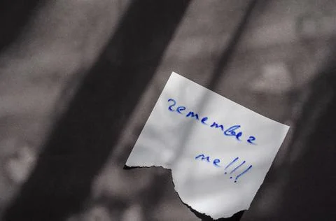Handwritten note Remember Me on a white piece of paper. Stock Photos