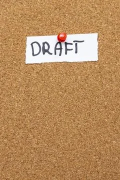 A handwritten note stating DRAFT pinned on a corkboard. The rustic texture of Stock Photos