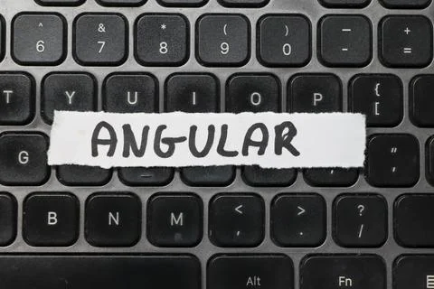 Handwritten note with the word ANGULAR on a computer keyboard. This concept Stock Photos