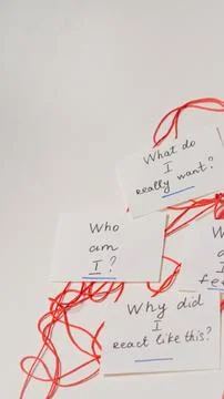 Handwritten notes on white background connected by red string for reflection Stock Photos