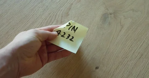 Handwritten PIN note being passed on Stock Footage 335213631