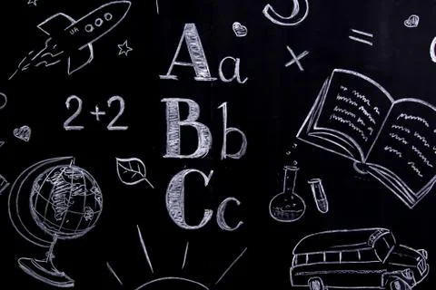 Handwritten school concept - globe, rocket, a, b,c, formulas etc on blackboard Stock Photos