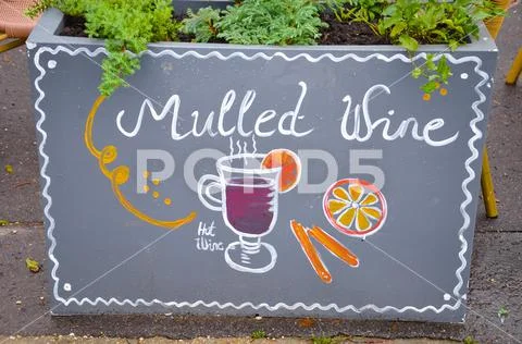Handwritten sign mulled and simple drawing of a mulled wine glass with orange Stock Photos