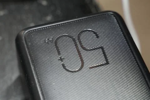 Handwritten text 50 on a black surface, showcasing a sleek design. The focus is Stock Photos