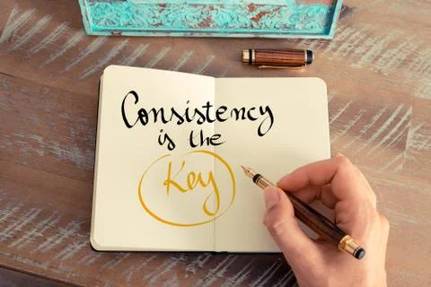 Handwritten text Consistency is the Key Stock Photos