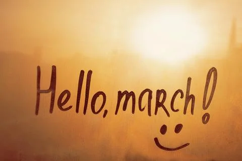 Handwritten text Hello march and smile on wet orange window Stock Photos