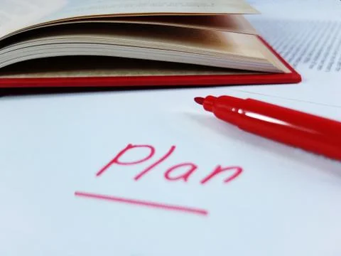 Handwritten Word Plan with Red Marker and Open Red Book Stock Photos