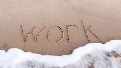 Handwritten WORK on a sandy sea beach is washed by the sea wave Stock Footage 153813231