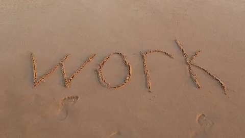 Handwritten WORK on a sandy sea beach is washed by the sea wave Stock Footage 153813233