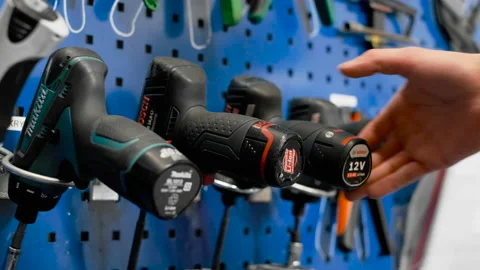 Handy husband handyman selecting tools drill tools drilling project stairs Stock Footage 156754473