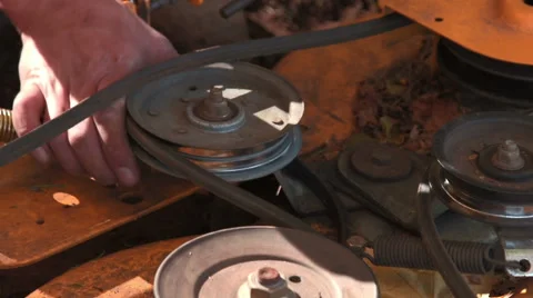 Handyman adjusting spring and gears to fix tractor Stock Footage 44778743