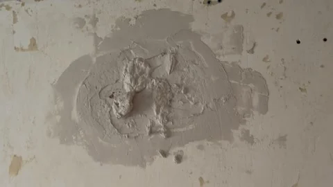 Handyman applying fresh plaster to a damaged wall 動画素材 341362937