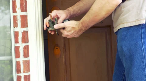 Handyman checking the fit of the new door knob 4k Stock Footage 37998907