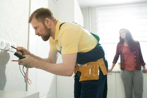 Handyman checking socket in flat Stock Photos