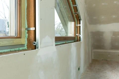 Handyman, construction man installing PVC window in a new insulated and fille Stock Photos