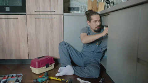 Handyman Fixing Leaking Sink Drain with Hand Tools in Kitchen Stock Footage 337007820
