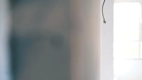 Handyman in goggle checks wall level at room renewal Stock Footage 120738225