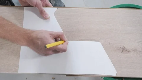 Handyman hands draw points in template angles on board Stock Footage 106376778