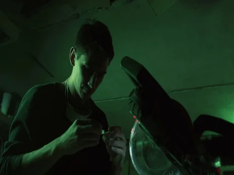 Handyman homeowner type using a power miter saw to cut a small piece of glass Stock Footage 73663526