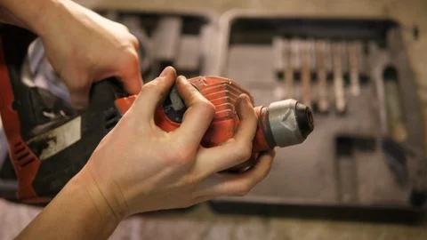 Handyman inspecting big old wired electric rusty Drilling device tool. POV. Stock Footage 126342552