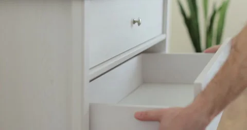 Handyman installing and adjusting drawer slide mechanism in contemporary kitchen 库存影片 329763557